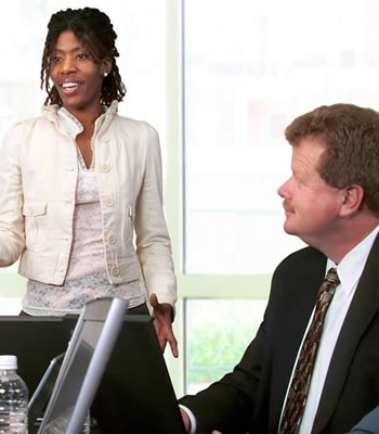 women standing speaking to two people